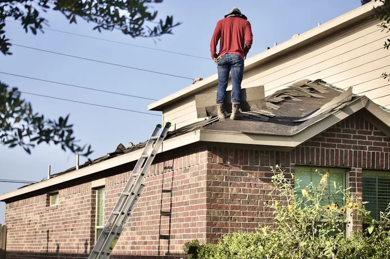 Professional roofer working on a residential roof in O Henry Oaks